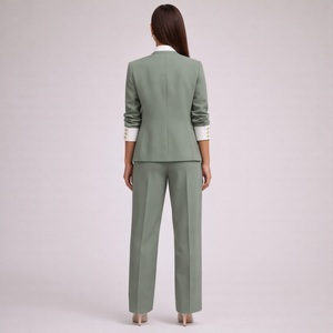 Woman wearing a green suit on a light gray background