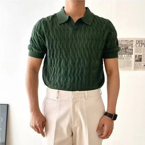 Person wearing a green textured shirt and beige pants against a light background