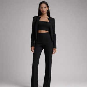 Woman wearing a black suit on a gray background