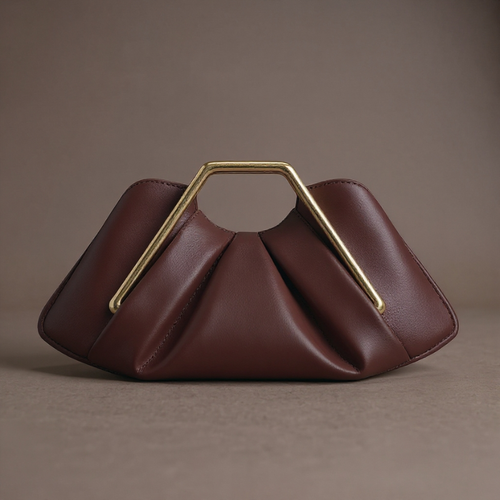 Brown handbag with a gold handle on a brown background