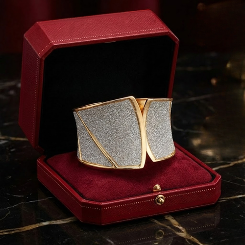 Gold and silver bracelete in a red jewelry box on a dark surface