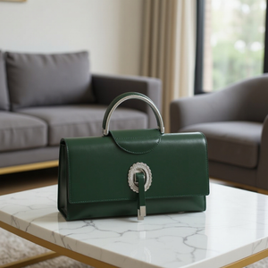 Green handbag with decorative clasp on a marble table in a living room setting