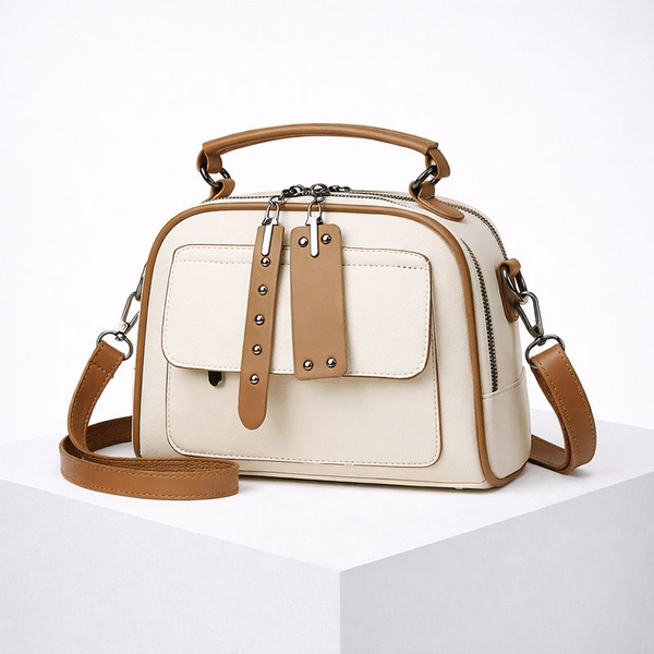 White handbag with brown accents on a white background