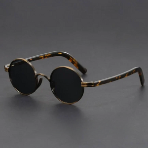Round sunglasses with tortoiseshell frame on a dark gray background