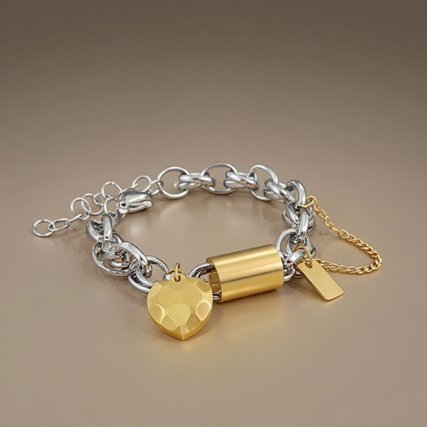 Silver bracelet with gold padlock and heart charm on a beige background