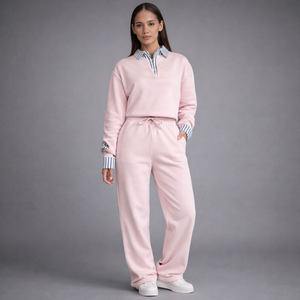 Woman wearing a pink tracksuit with a gray background