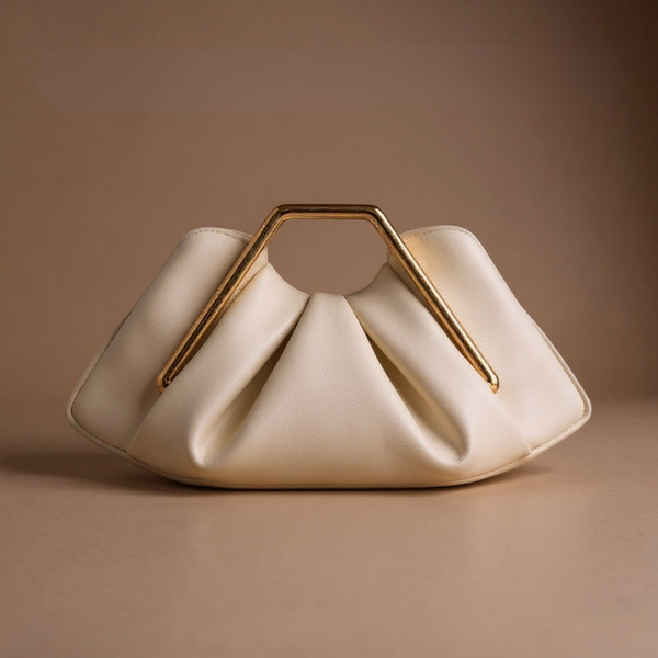 Cream-colored handbag with a gold handle on a brown background