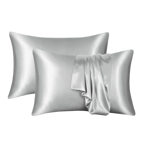 Two silver satin pillowcases on a white background