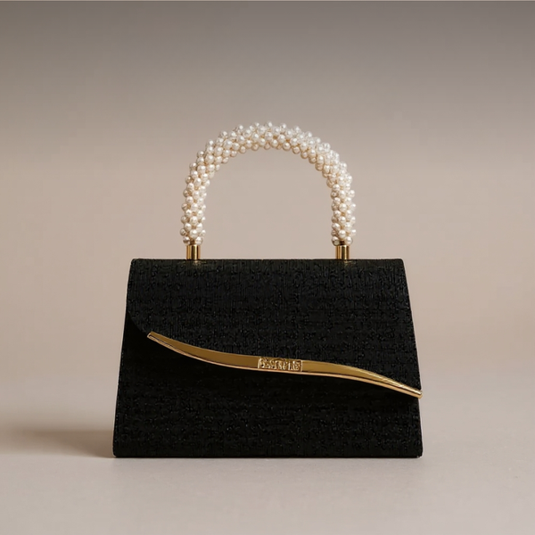 Black handbag with pearl handle on a beige background