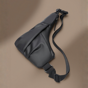 Black sling bag on a brown background