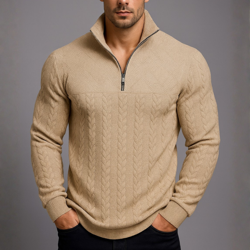 Beige cable knit sweater worn by a person on a gray background