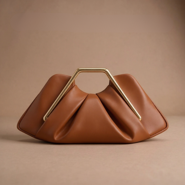 Brown handbag with a gold handle on a beige background