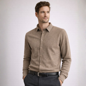 Man wearing a brown button-up shirt and dark pants on a light gray background