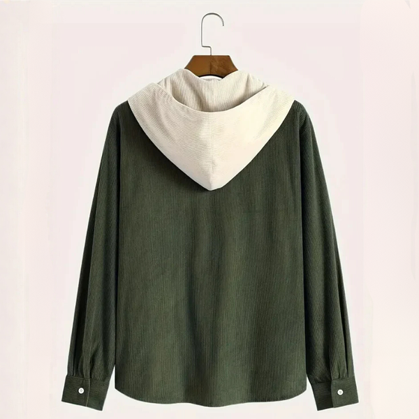 Green jacket with white collar on a hanger against a light pink background