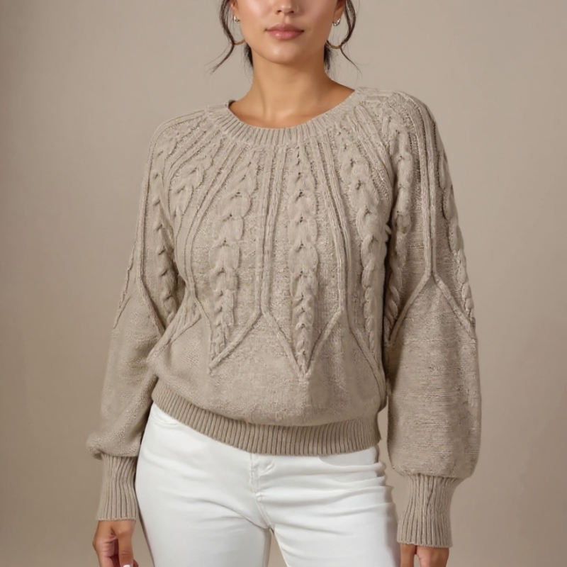 Woman wearing a white cable knit sweater and blue jeans against a beige background