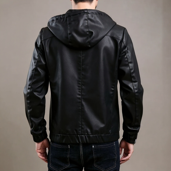 Person wearing a black leather jacket with a hood on a plain background