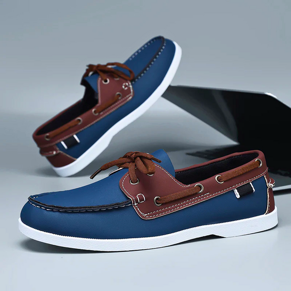 Blue and brown loafers on a reflective surface with a blurred background
