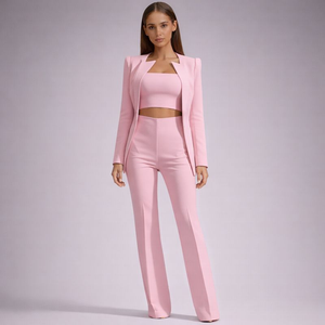 Woman wearing a pink suit on a plain background