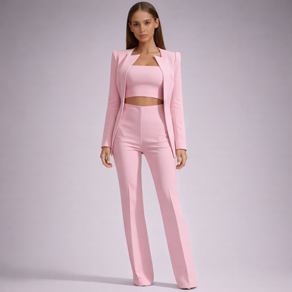 Woman wearing a pink suit on a plain background