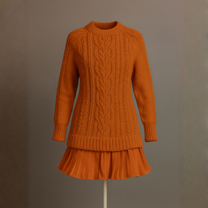 Orange cable knit dress on a mannequin against a plain background