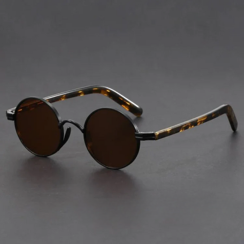 Round sunglasses with tortoiseshell frame on a dark gray background
