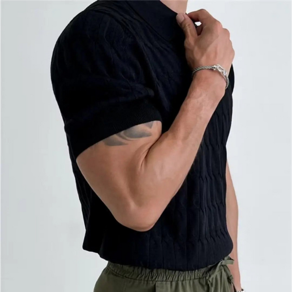 Person wearing a black sleeveless top with a plain background