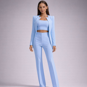 Woman wearing a light blue outfit on a gray background