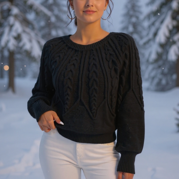 Person wearing a black cable knit sweater in a snowy landscape