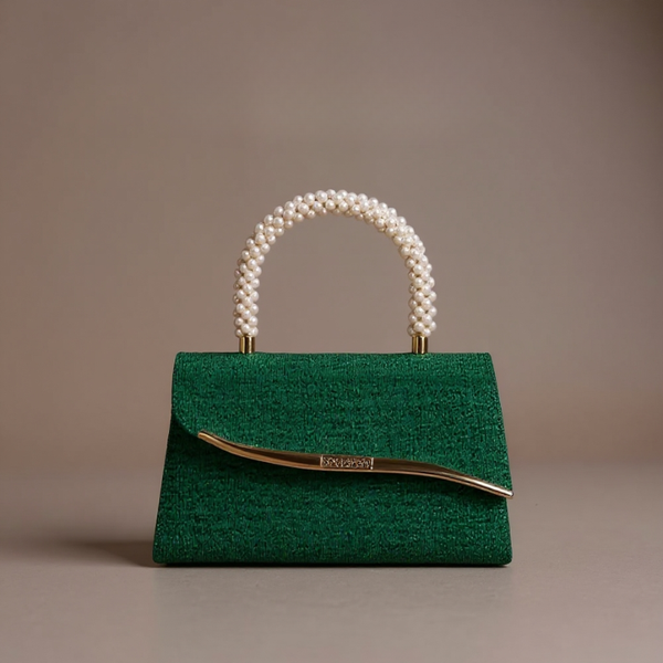 Green handbag with pearl handle on a beige background