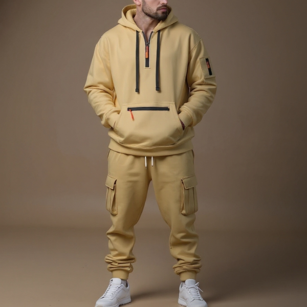 Man wearing a beige tracksuit with cargo pockets on a brown background