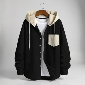 Black hoodie with beige lining on a hanger against a gray background