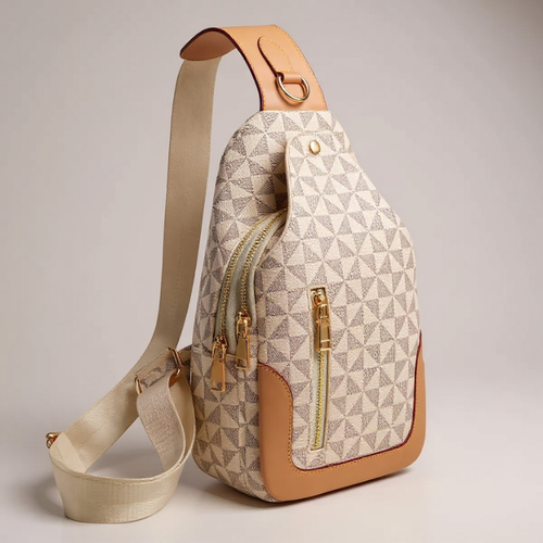 Sling bag with geometric pattern and gold zippers on a neutral background
