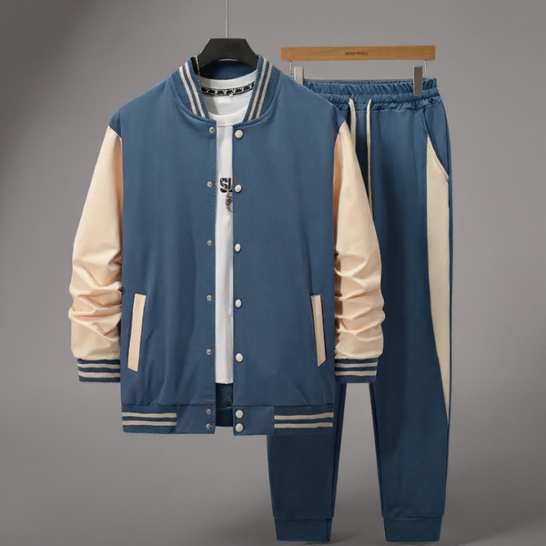 Blue and beige varsity jacket and pants set on a gray background