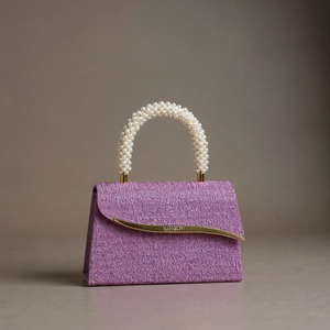 Purple handbag with pearl handle on a gray background