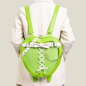Green heart-shaped backpack with a bow and laces on a plain background