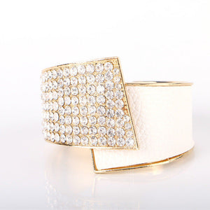 Gold ring with diamond accents on a white background