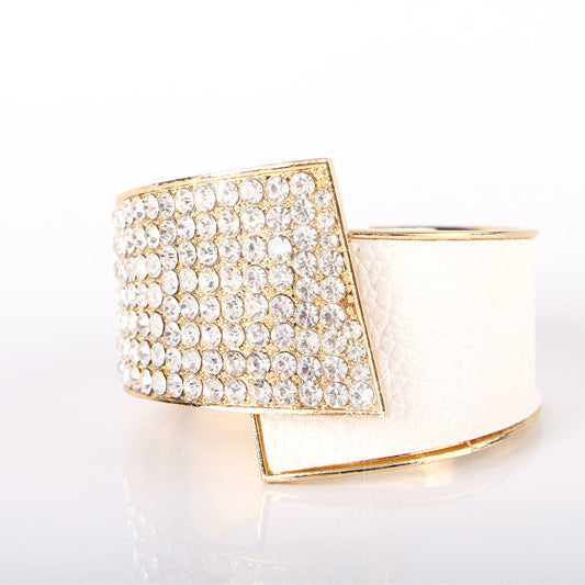 Gold ring with diamond accents on a white background