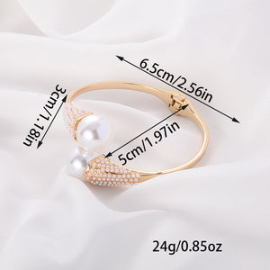 Gold bracelet with pearls and measurements on a white background