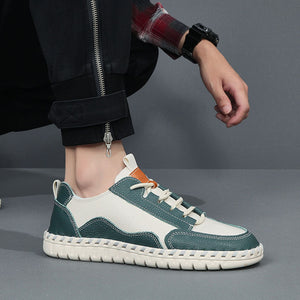 Person wearing green and white sneakers on a gray background