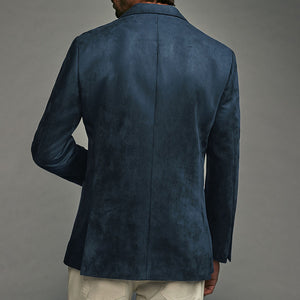 Blue suede jacket worn by a person on a gray background