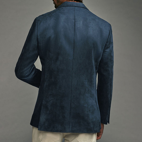 Blue suede jacket worn by a person on a gray background