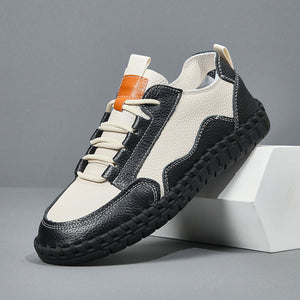 Black and white sneakers with orange accents on a gray background