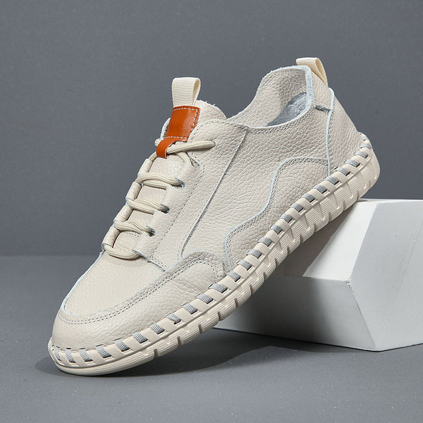 Beige sneaker with brown accent on a gray background