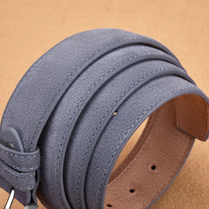 Close-up of a gray suede leather belt on a beige background