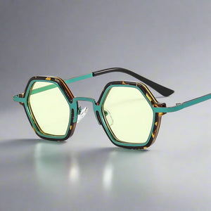Sunglasses with green lenses and a tortoiseshell frame on a white background