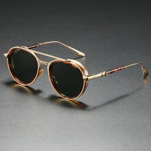 Gold-framed sunglasses with dark lenses on a gray surface