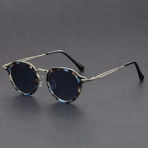 Sunglasses with tortoiseshell frame and dark lenses on a gray background