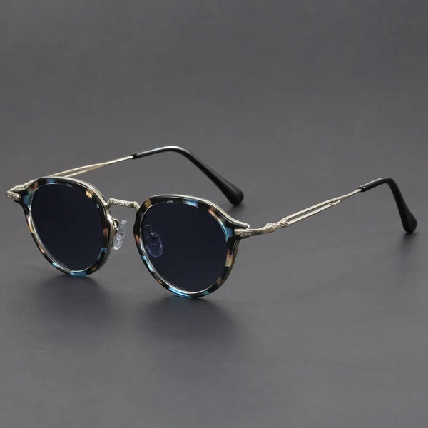 Sunglasses with tortoiseshell frame and dark lenses on a gray background