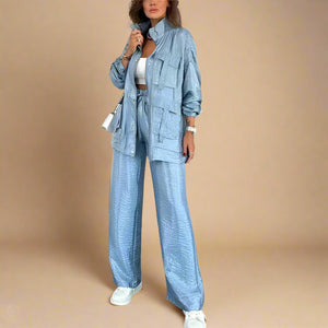 Woman wearing a blue denim outfit in a modern living room.