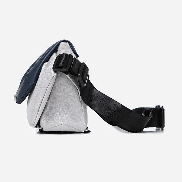 Silver and black crossbody bag on a light gray background